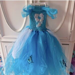 Cinderella Blue and White Tulle Dress with Butterfly Accents will fit a size 4-6
